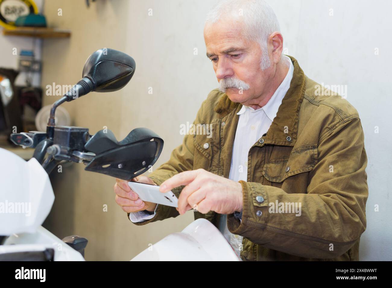 man taking picture of a scooter Stock Photo