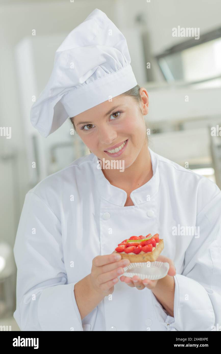 a chef woman holding pastry Stock Photo