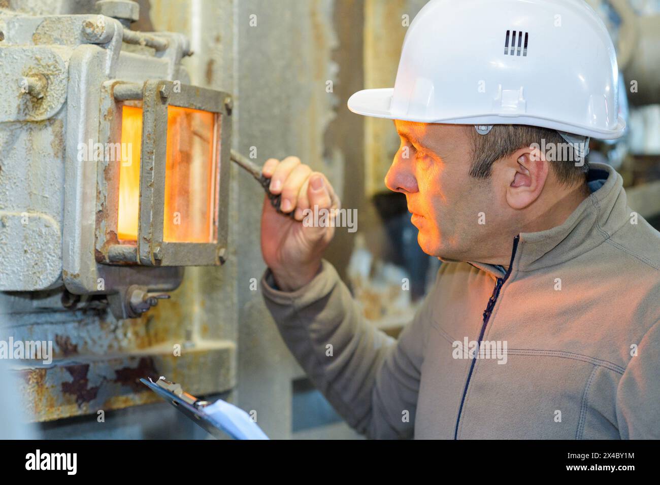 male worker checking fire factory Stock Photo - Alamy