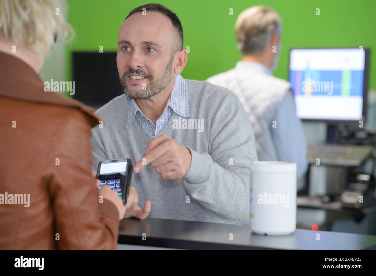 man paying bill through smartphone using nfc technology in cafe Stock Photo