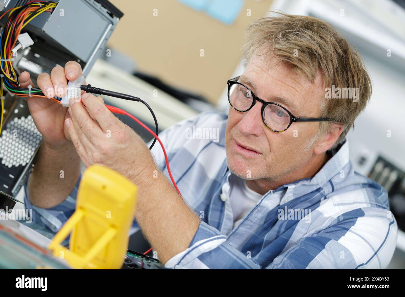 technician using voltage meter for voltage measurement in computer ...