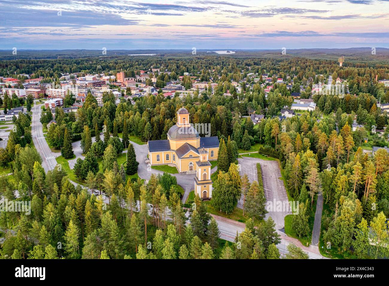 Finland, Kainuu. Aerial view of Evangelical Lutheran church and the city of Kuhmo at dusk Stock Photo