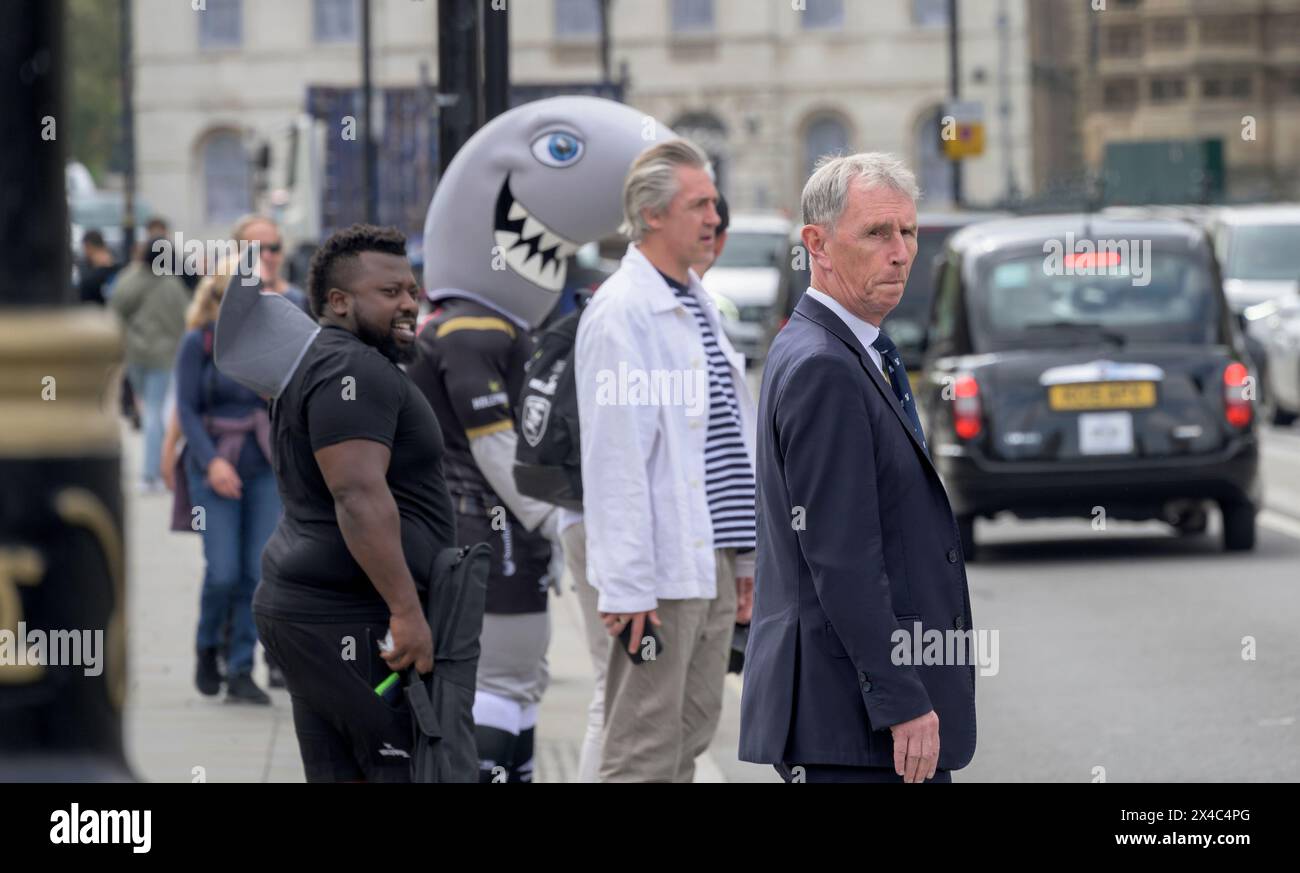 Nigel Evans MP (Con: Ribble Valley) Deputy Speaker in the House of Commons. In Parliament Square with a man in a shark costume behind Stock Photo