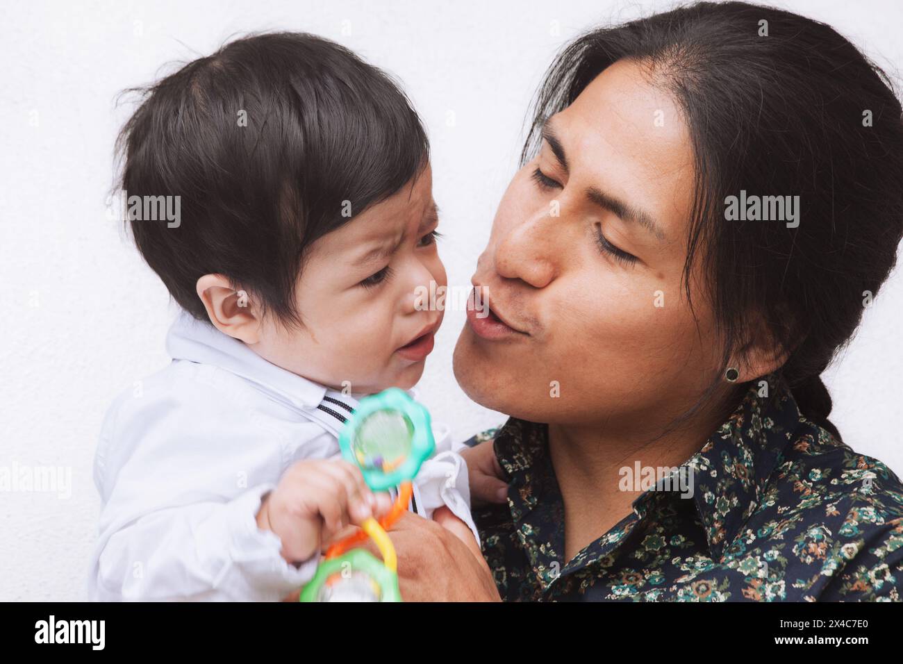 An Ecuadorian father shows affection to his baby, highlighting family ...