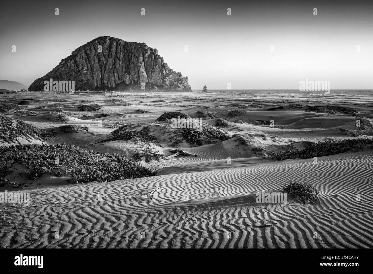 USA, California, Central Coast, Morro Bay. Dunes and Morro Rock at sunset Stock Photo