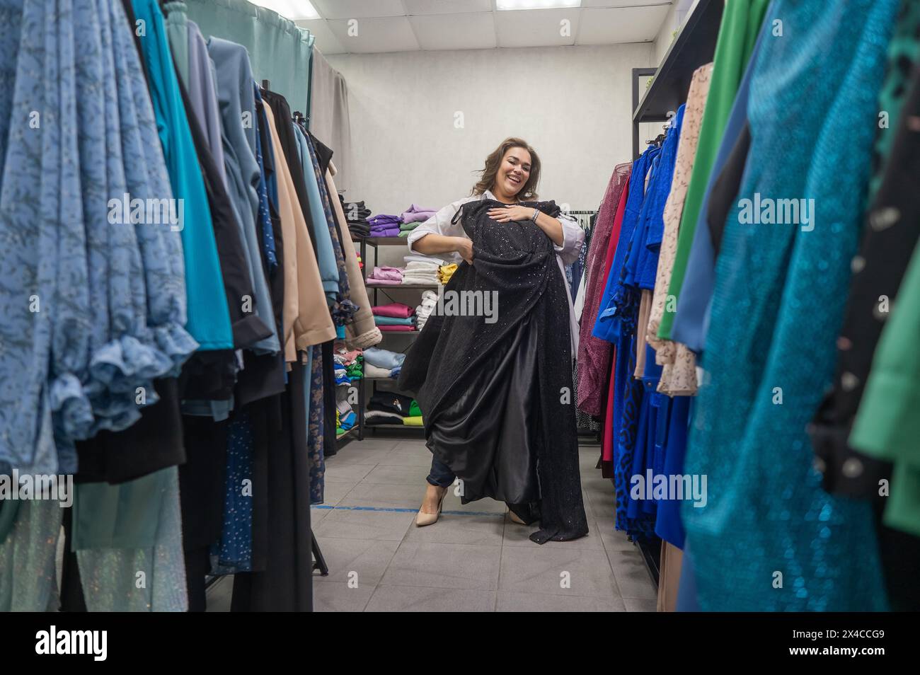 A fat woman chooses clothes in a plus size store Stock Photo - Alamy