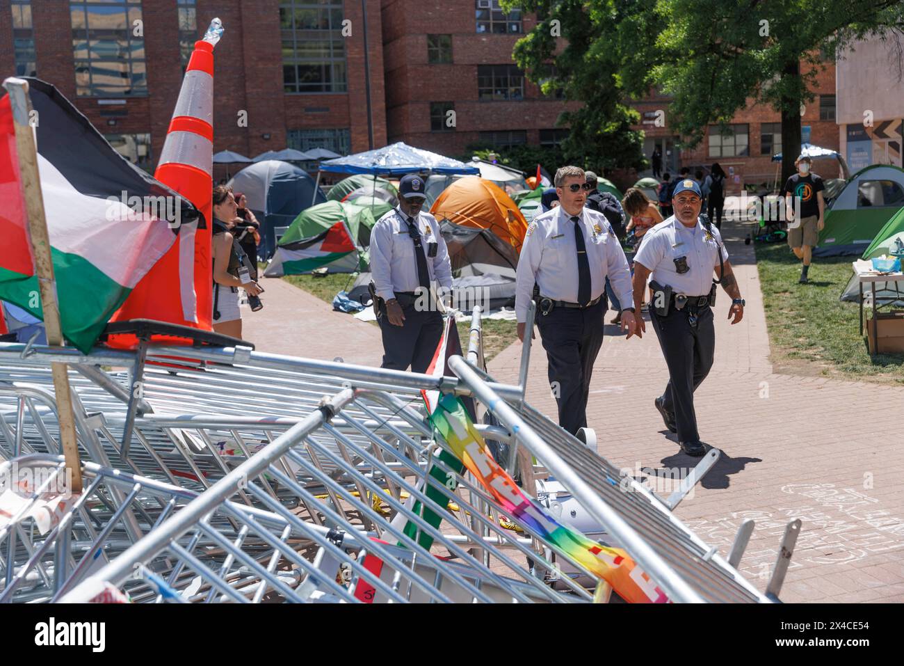 United States Capitol Police Officers walk past a tower of barricades ...