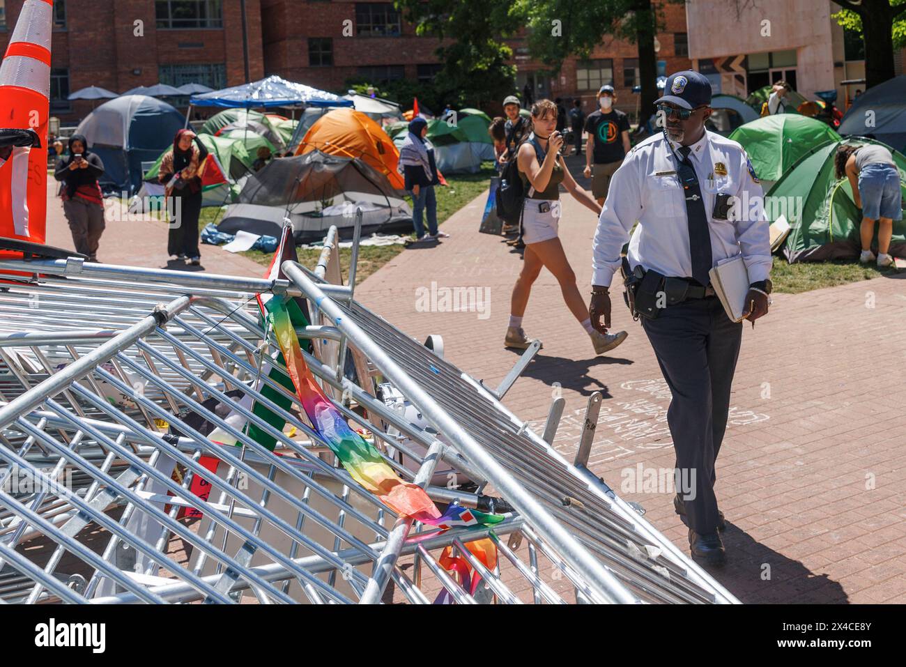 United States Capitol Police Officers walk past a tower of barricades in the center of a pro-Palestinian encampment on the campus of George Washington University in Washington DC is seen on Wednesday, May 1, 2024. House Oversight Republicans visited the encampment ahead of a press conference steps away. Credit: Aaron Schwartz / CNP /MediaPunch Stock Photo
