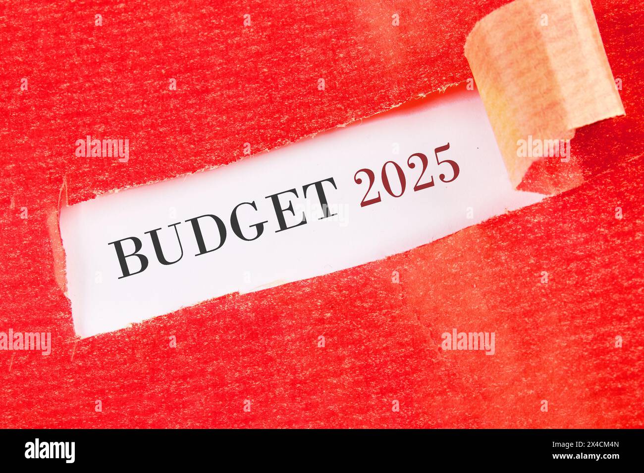 Business concept. The inscription BUDGET 2025 under the torn paper on a