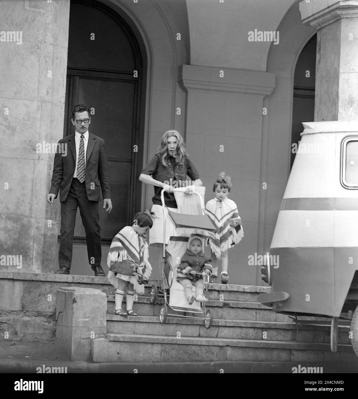 Socialist Republic of Romania in the 1970s. A family with small children going down a flight of stairs in downtown Bucharest. Stock Photo