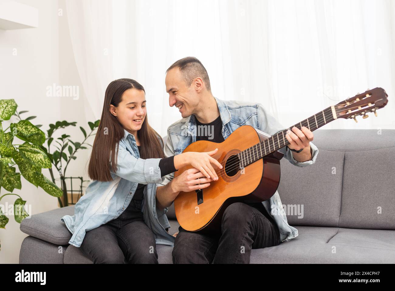 Happy family Father and daughter playing guitar. Father's day Stock ...