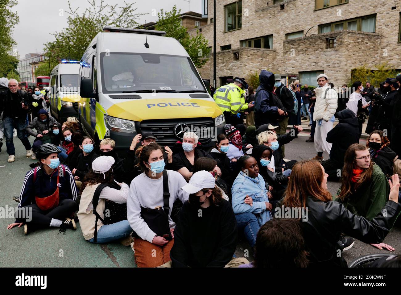 London / UK. 02 May 2024. Protestors block Peckham High street outside Great Western Hotel to prevent the removal of refugees to the Bibby Stockholm barge. Alamy Live News / Aubrey Fagon Stock Photo