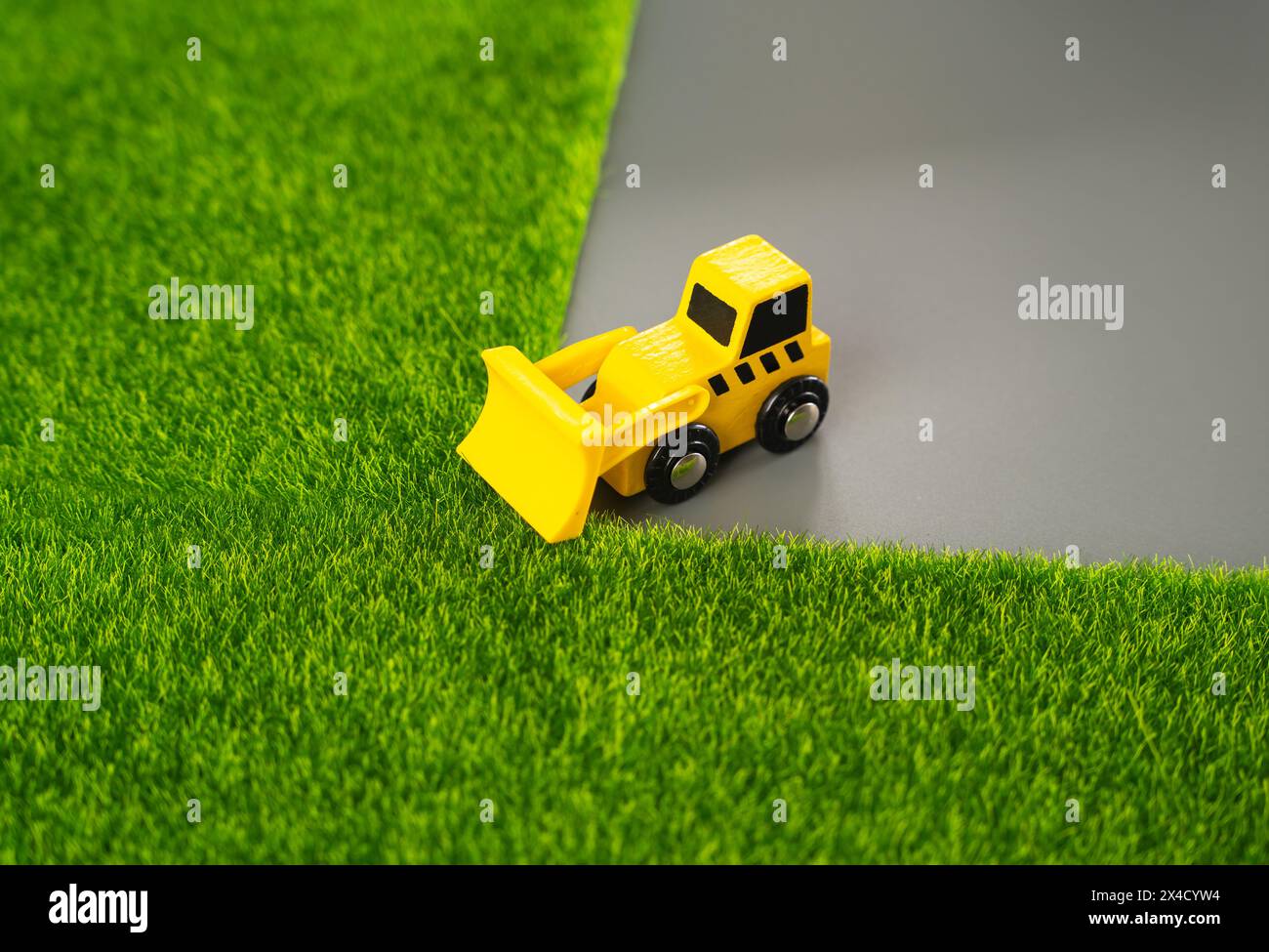 A bulldozer destroys nature, clearing the area for new construction. Harms to environment and natural diversity. Protection of natural resources. Redu Stock Photo