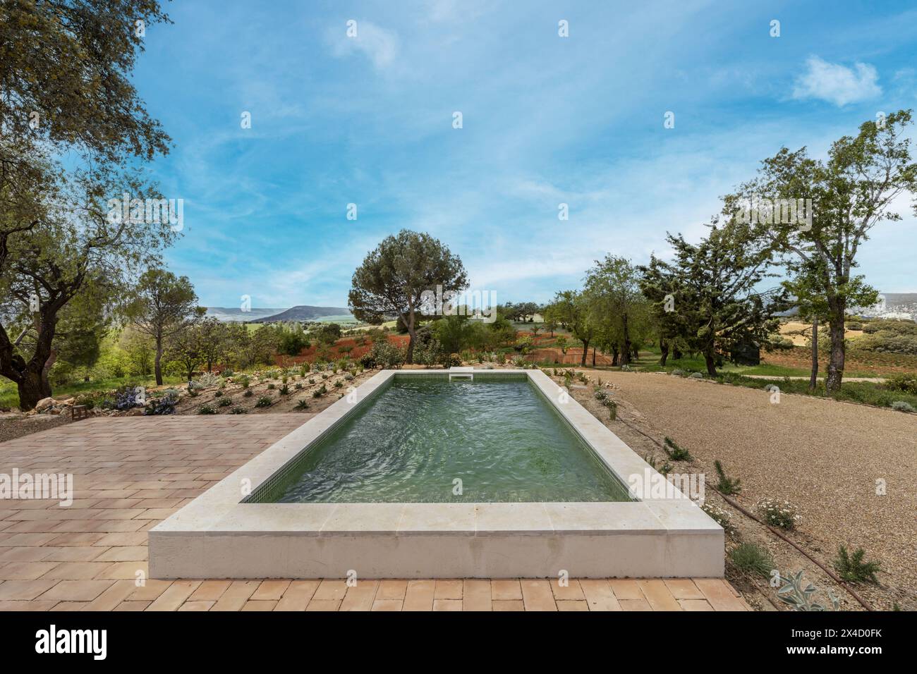 A pretty green-tiled outdoor pool with magnificent countryside views ...