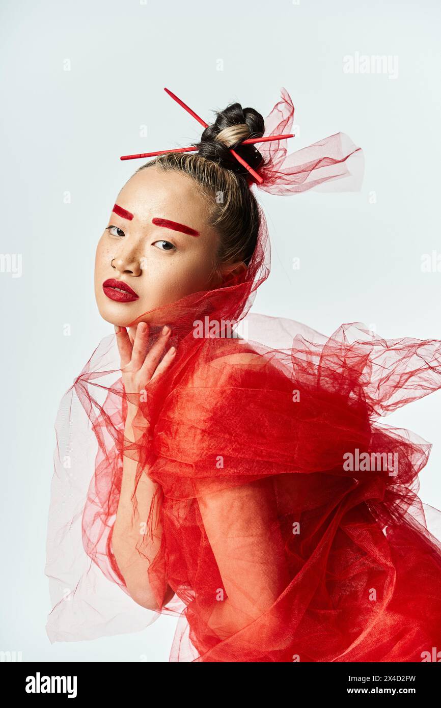 Asian woman in red dress and veil posing gracefully Stock Photo - Alamy