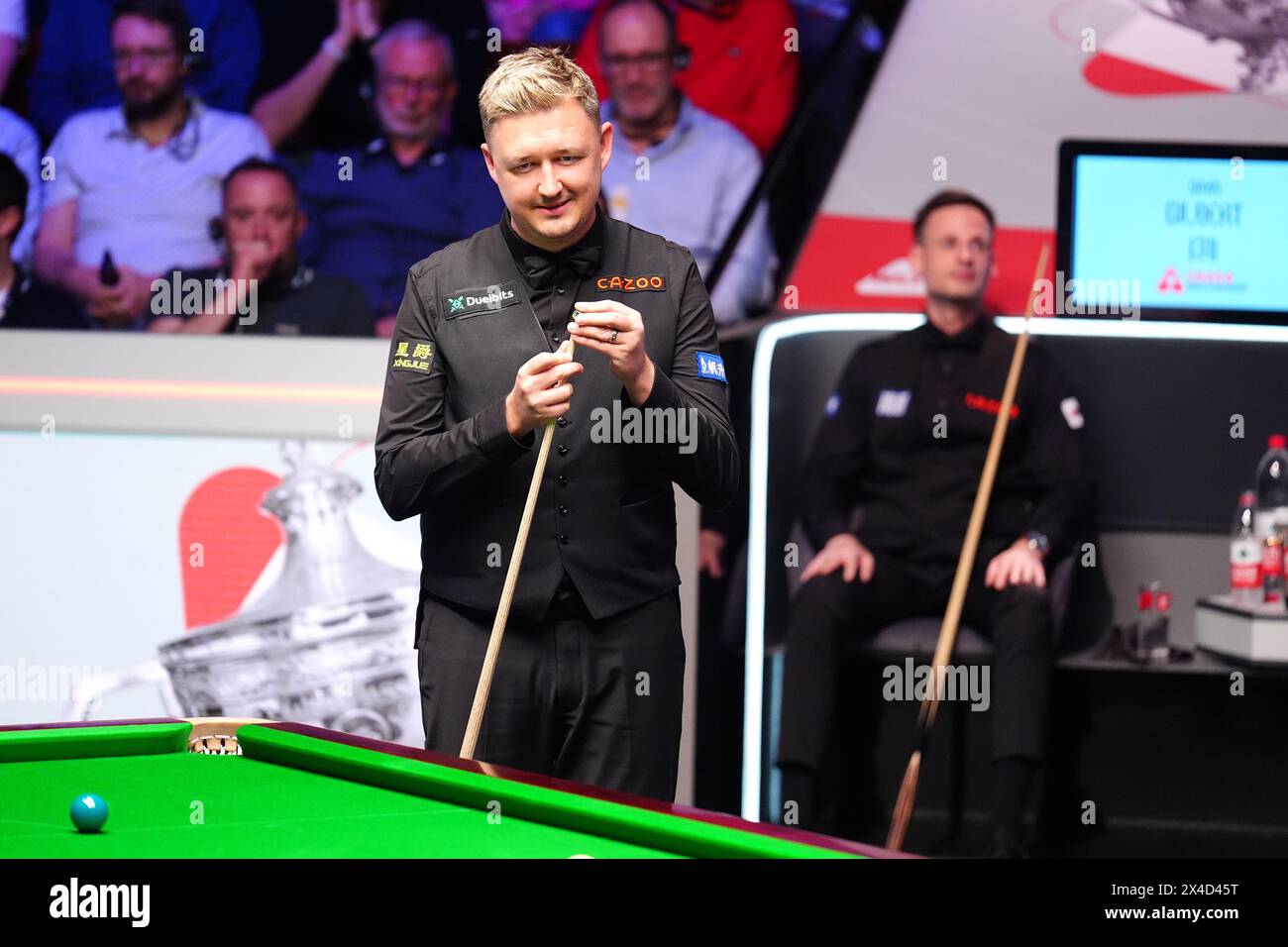 Kyren Wilson (left) in action as David Gilbert looks on during the semi-final match on day thirteen of the 2024 Cazoo World Snooker Championship at the Crucible Theatre, Sheffield. Picture date: Thursday May 2, 2024. Stock Photo