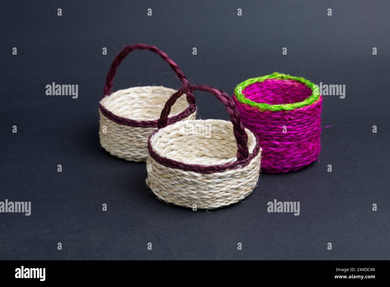 three empty jute bucket on black background. Stock Photo