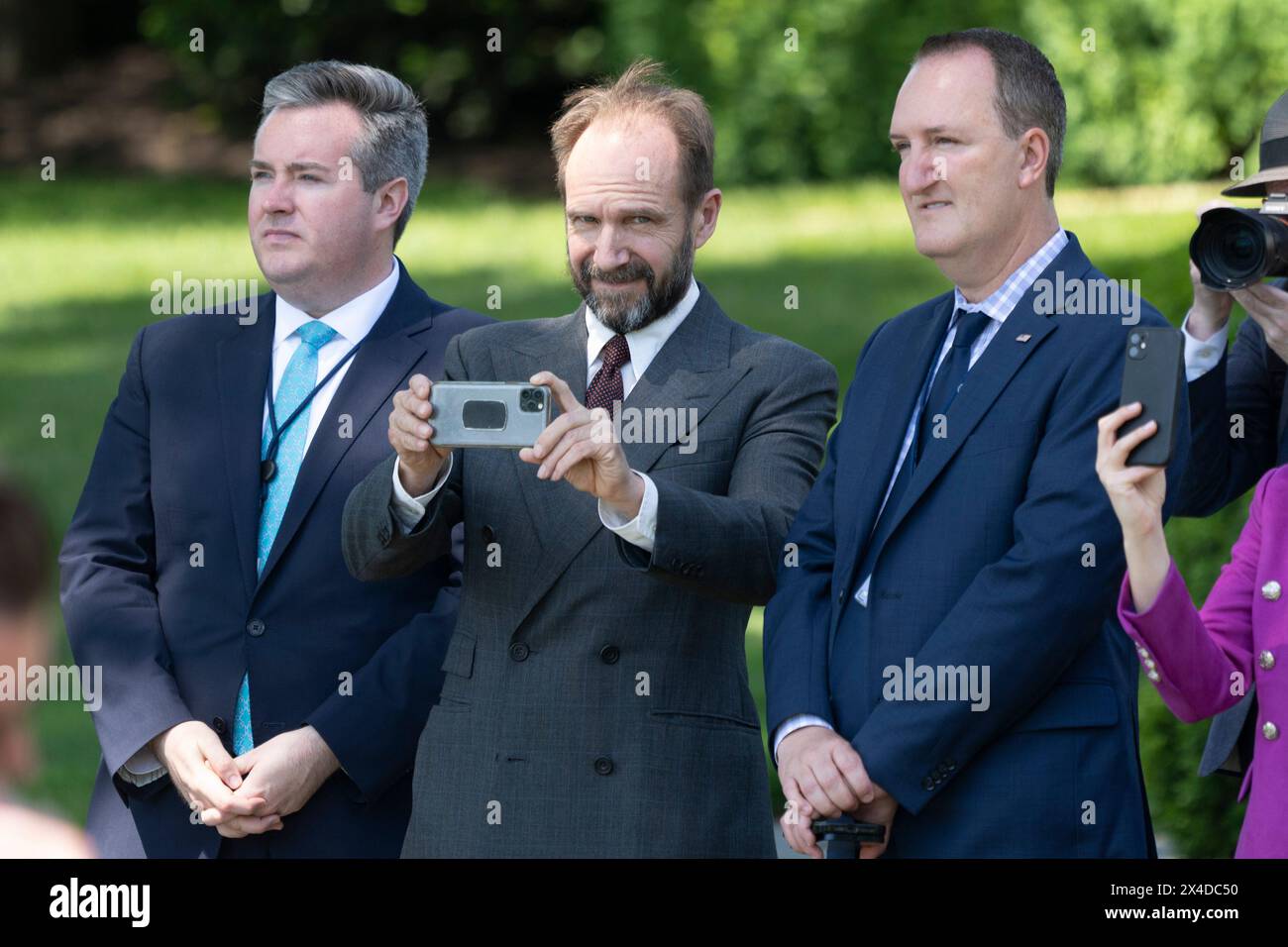 Washington, United States. 01st Apr, 2024. Actor Ralph Fiennes (C) takes a picture as President Joe Biden boards Marine One at the White House in Washington, DC, enroute to North Carolina on Thursday, May 2, 2024. Photo by Chris Kleponis/UPI Credit: UPI/Alamy Live News Stock Photo