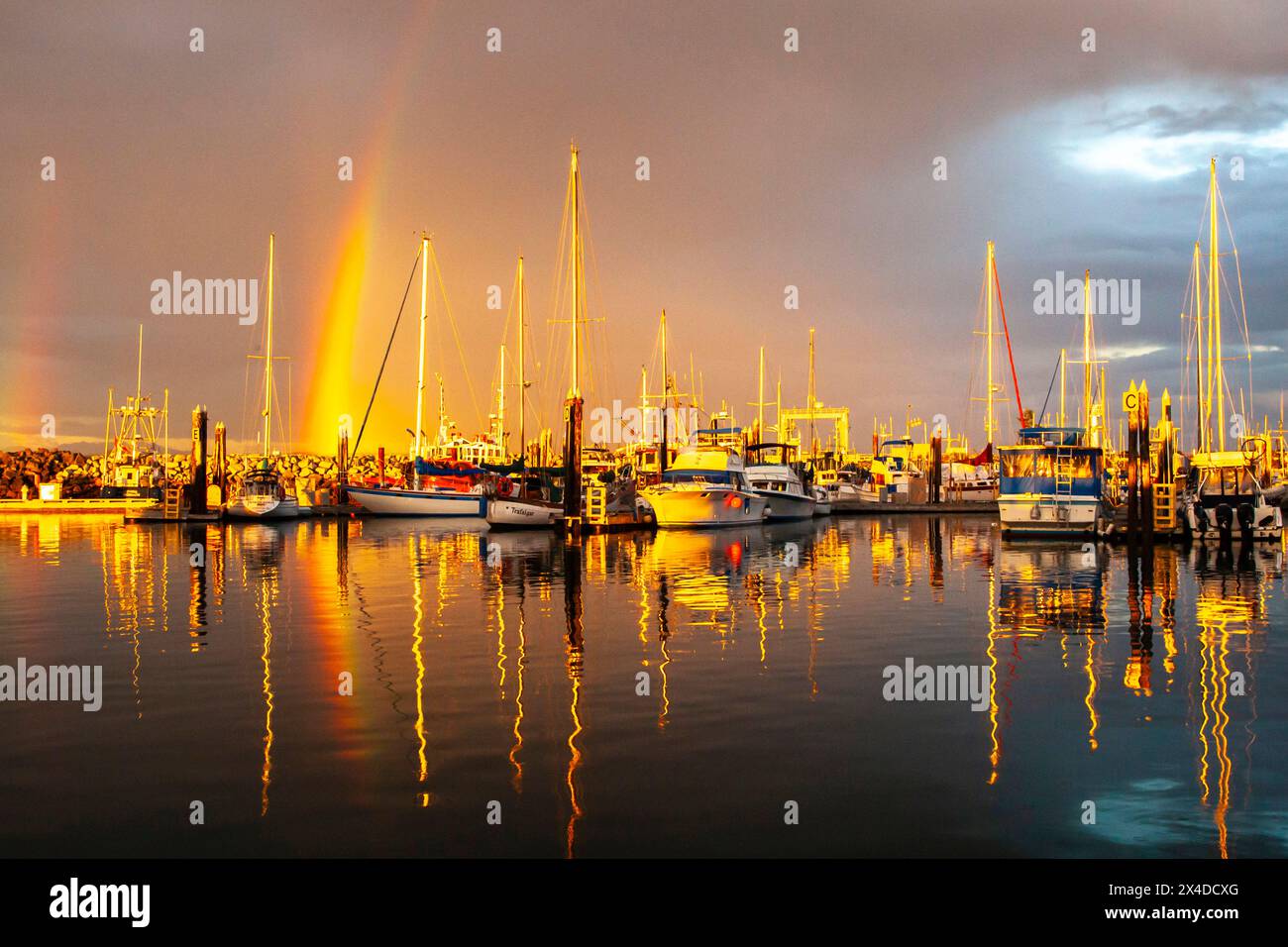 Canada, British Columbia, Inside Passage. Rainbow and Port McNeil marina at sunset. (Editorial Use Only) Stock Photo