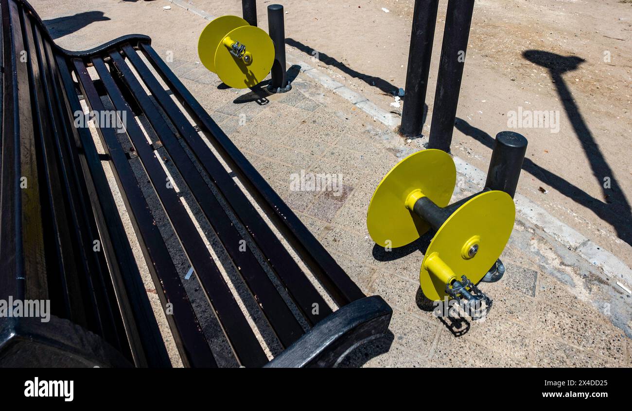 Outdoor Fitness Equipment Next to a Park Bench on a Sunny Day Stock Photo