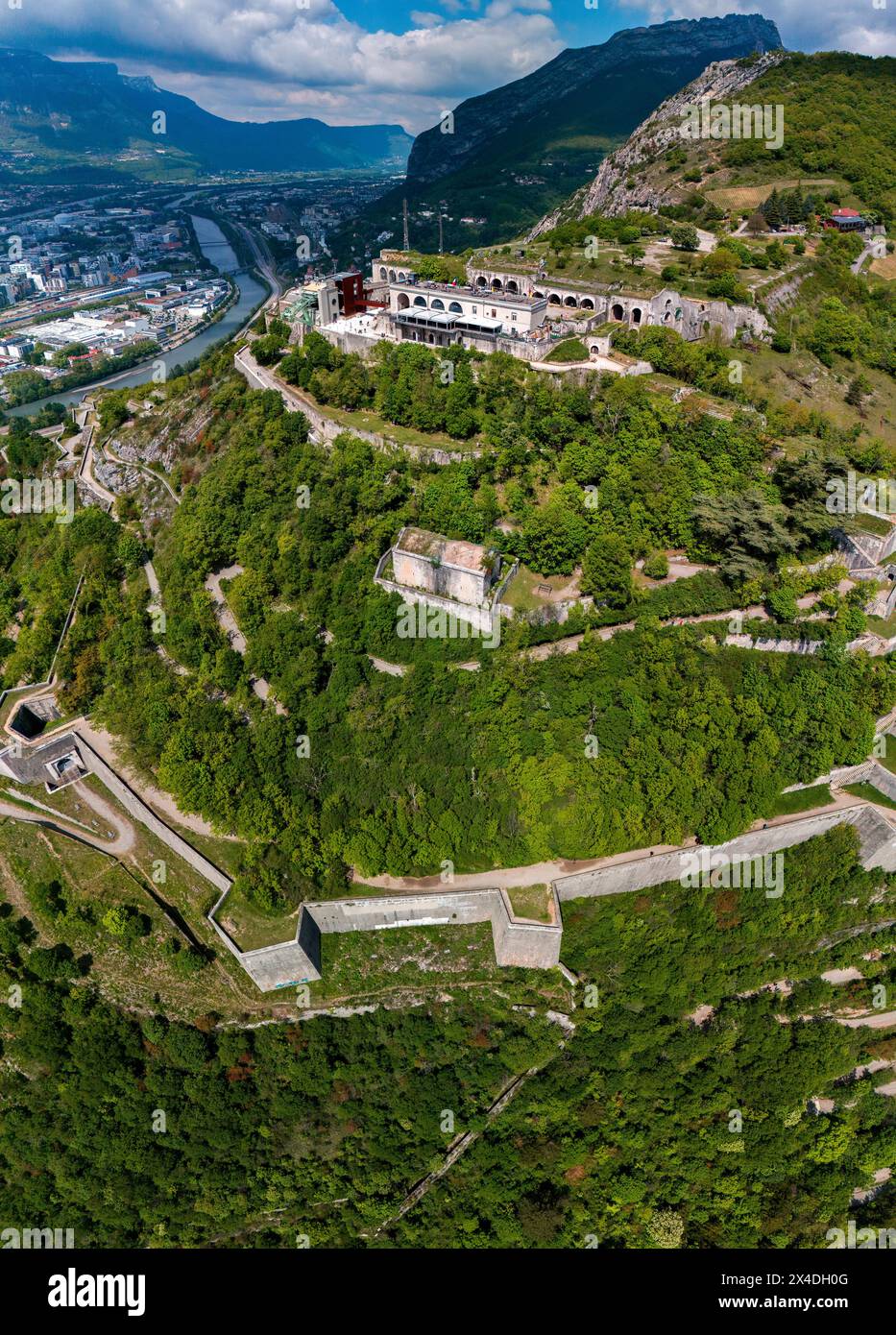 Aerial view of Grenoble's Bastille fort, city skyline crossed by the river and surrounded by mountains. France Stock Photo