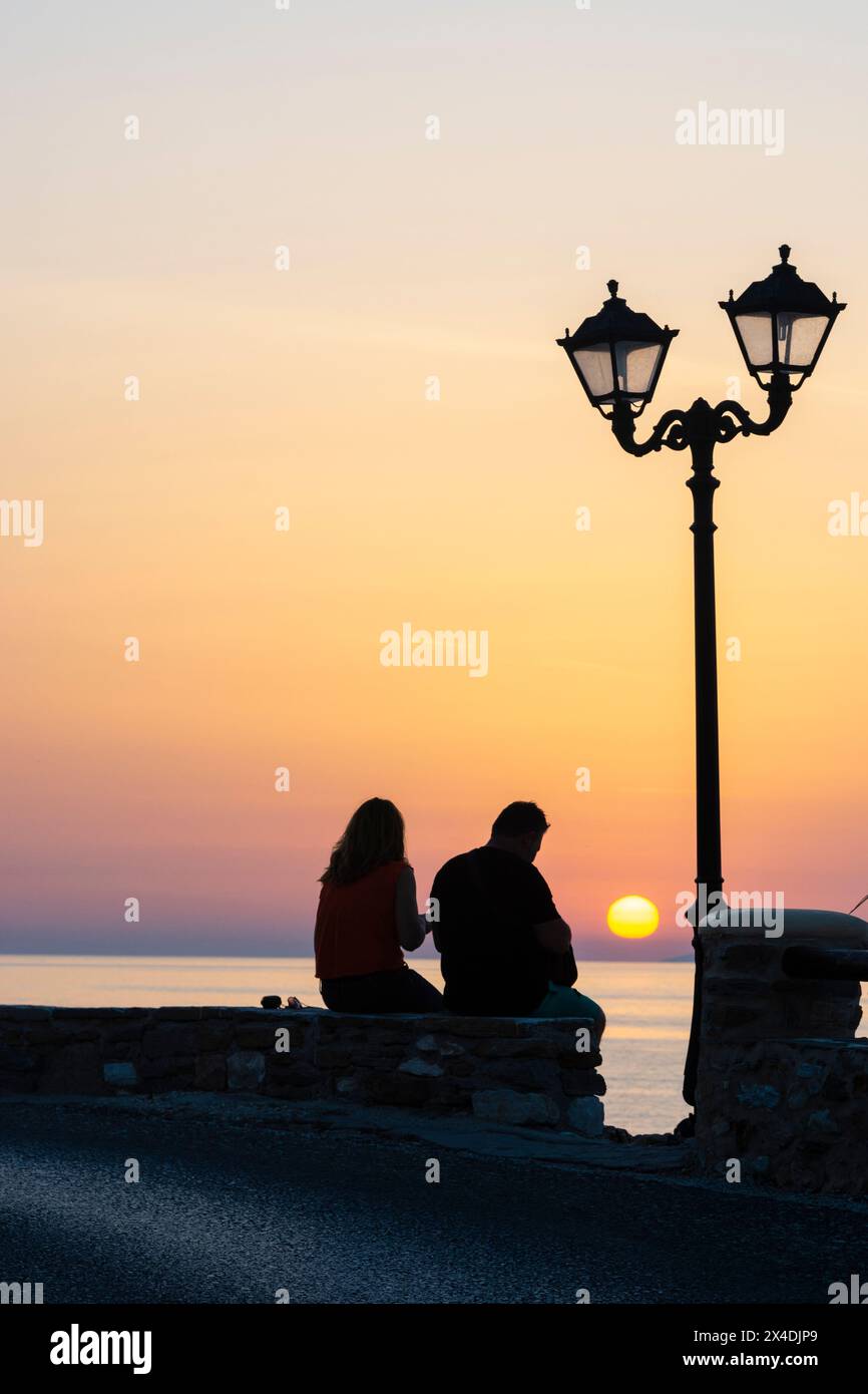 A couple enjoying the sunset in Parikia, Paros Island, Cyclades Islands, Greece. Stock Photo