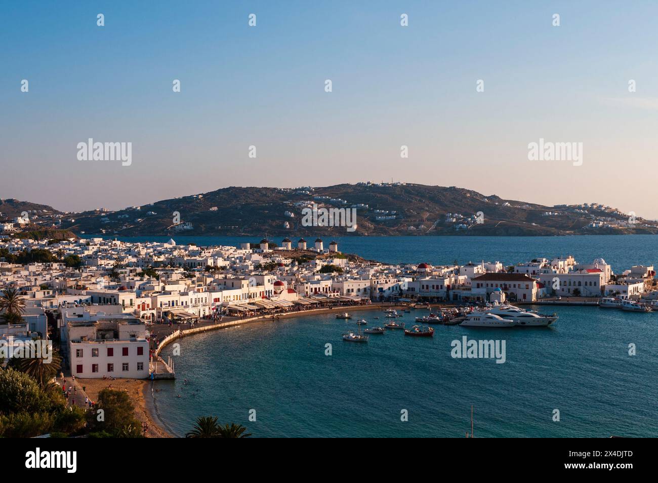 A scenic view of Chora and the nearby sea at sunset. Chora, Mykonos Island, Cyclades Islands, Greece. Stock Photo