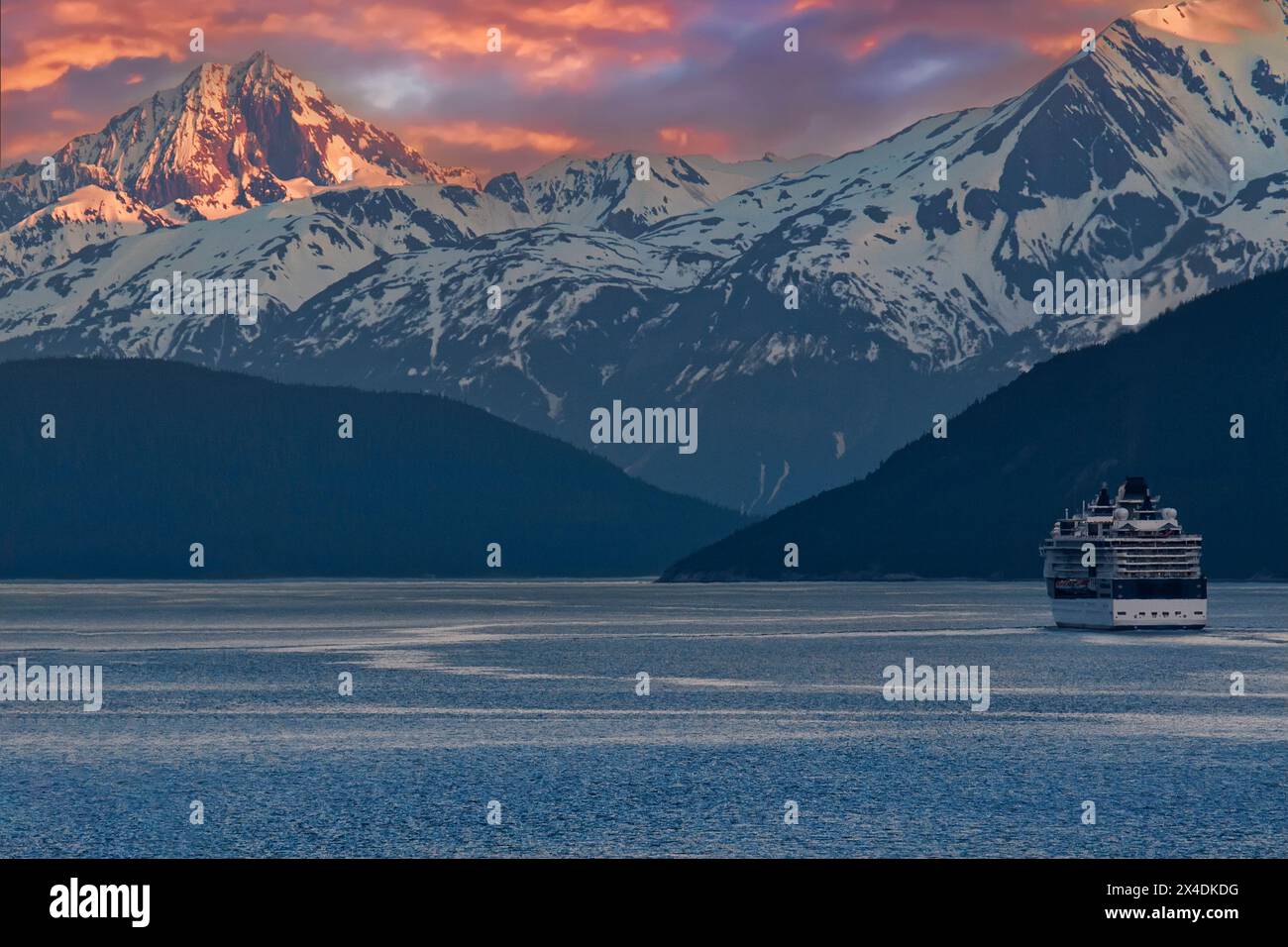 Cruise ship in the Inside Passage at days end, beautiful Alaska mountain range. Stock Photo