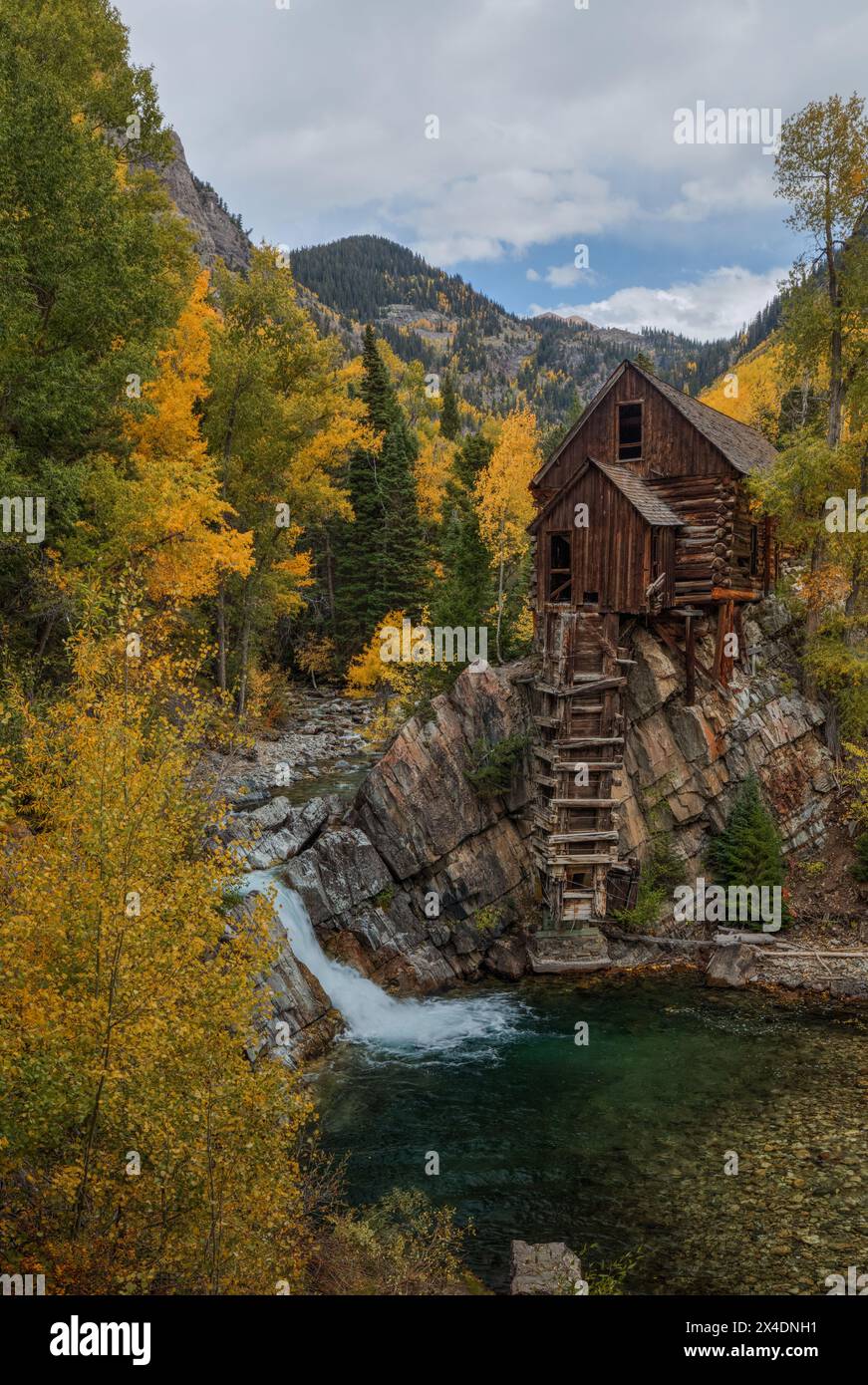 Scenic image of long waterfall falling down mountainside Stock Photo ...
