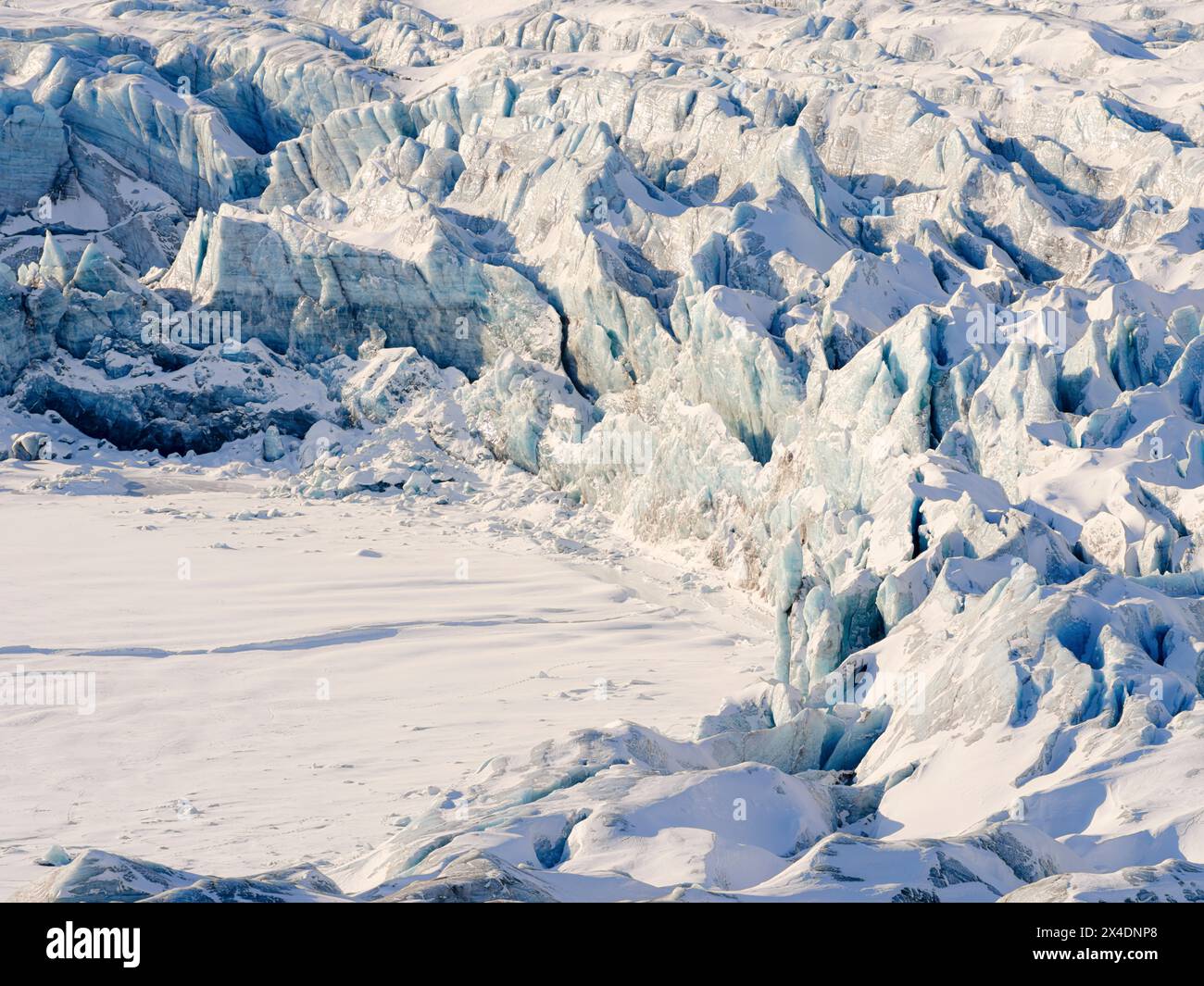 Glacier front of Fridtjovbreen and the frozen fjord Van Mijenfjorden. Landscape in Van Mijenfjorden National Park, (former Nordenskiold National Park) Stock Photo