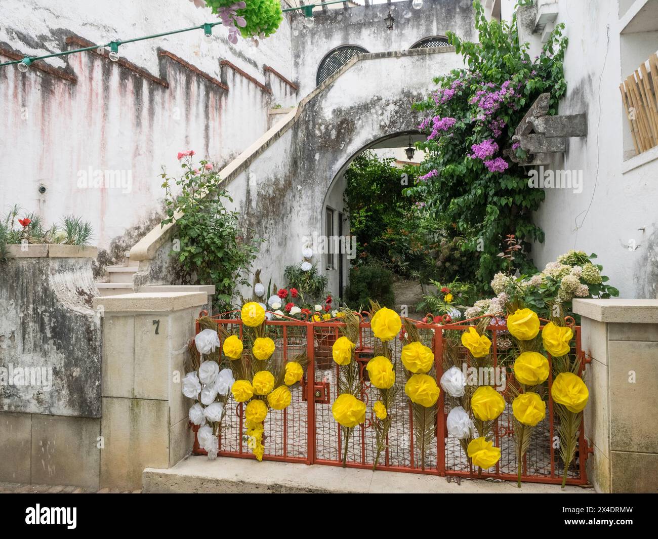 Gate and entrance to home decorated with paper flowers during the Festa ...