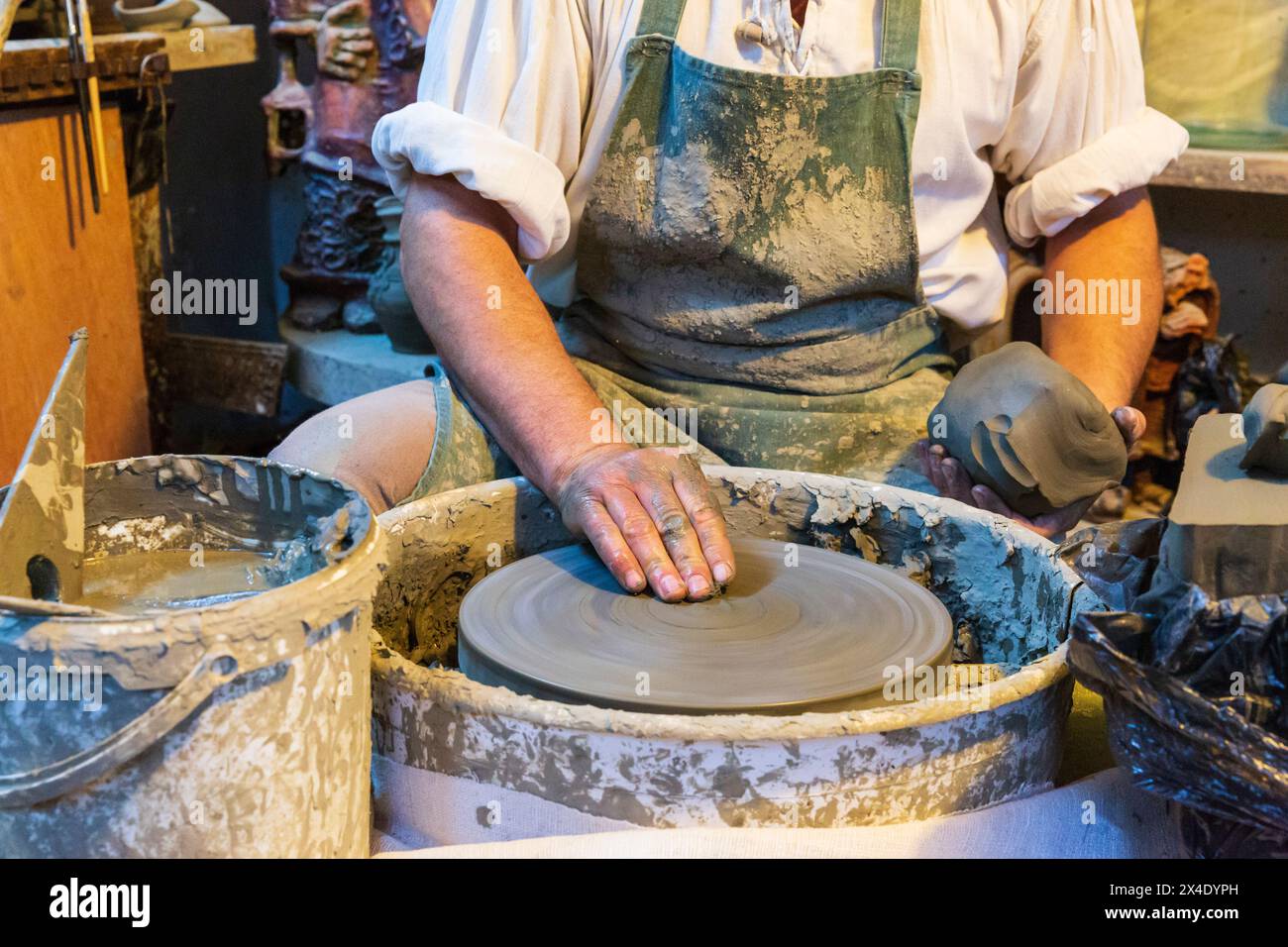 Romania, Transylvania, Maramures, Baie Mare. Casa Ola Rului. Traditional Romanian clay pottery exhibit. Potter and his wheel. (Editorial Use Only) Stock Photo