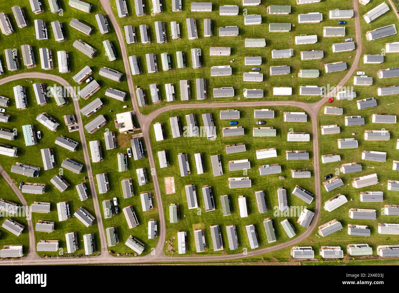 Aerial top down view of a large group of static caravans on a trailer park or holiday home site Stock Photo