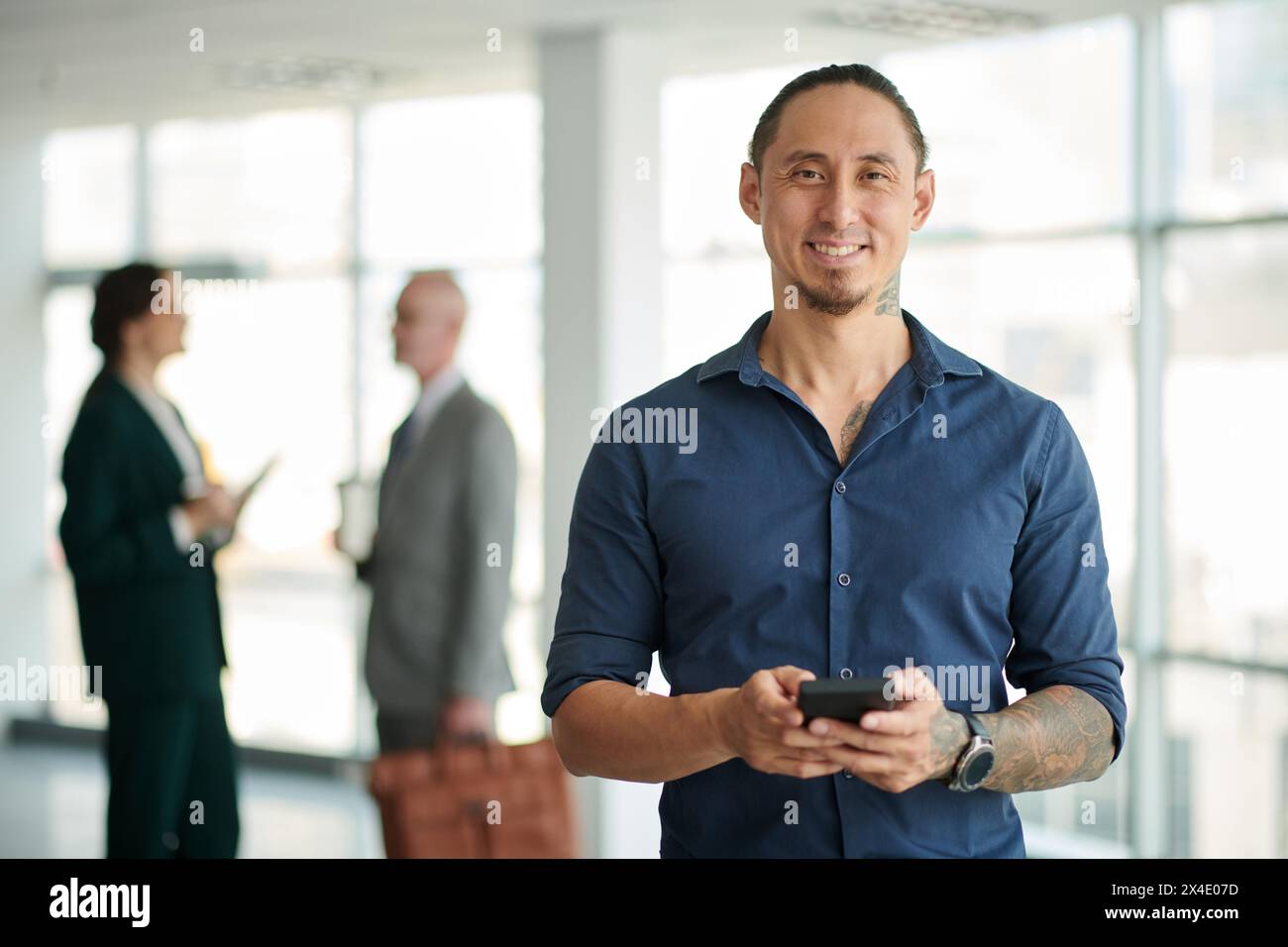 Portrait of smiling successful businessman using mobile app Stock Photo