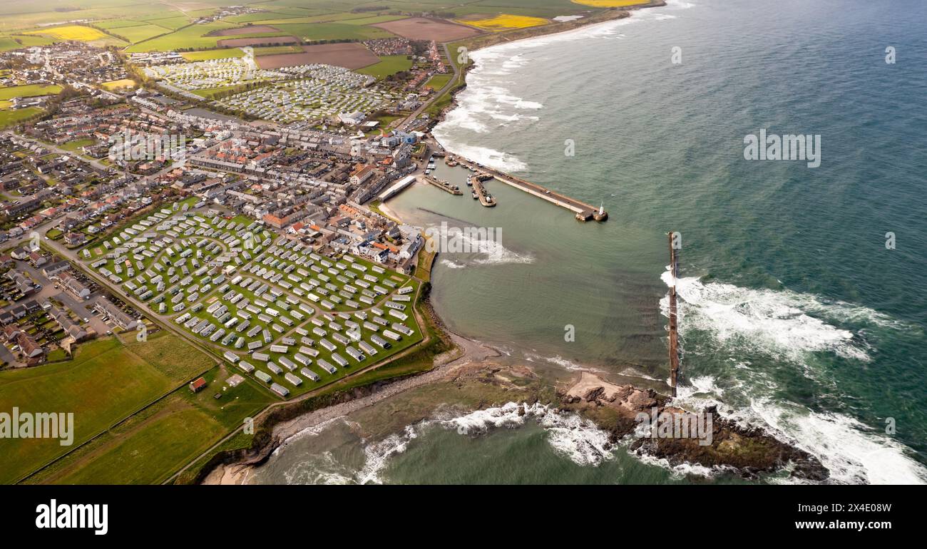 Aerial landscape panorama of the popular tourist resort of  Seahouses town and harbour with large caravan parks for seaside holidays in Northumberland Stock Photo