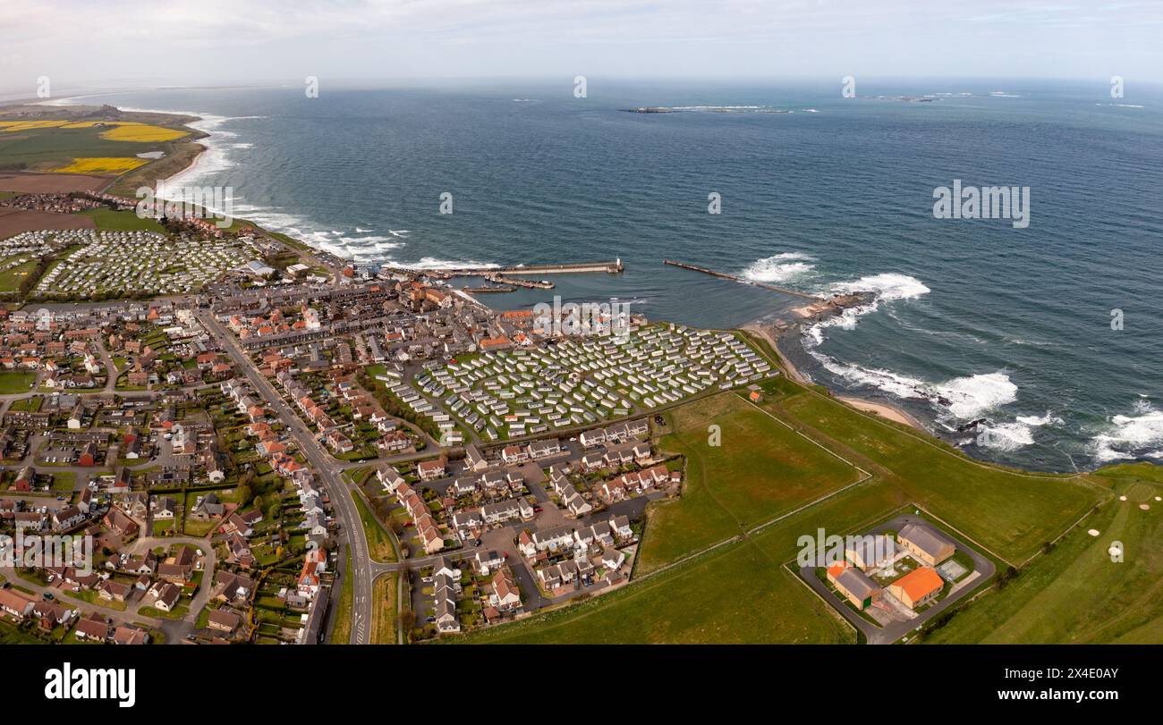 Aerial landscape panorama of the popular tourist resort of  Seahouses town and harbour with large caravan parks for seaside holidays in Northumberland Stock Photo