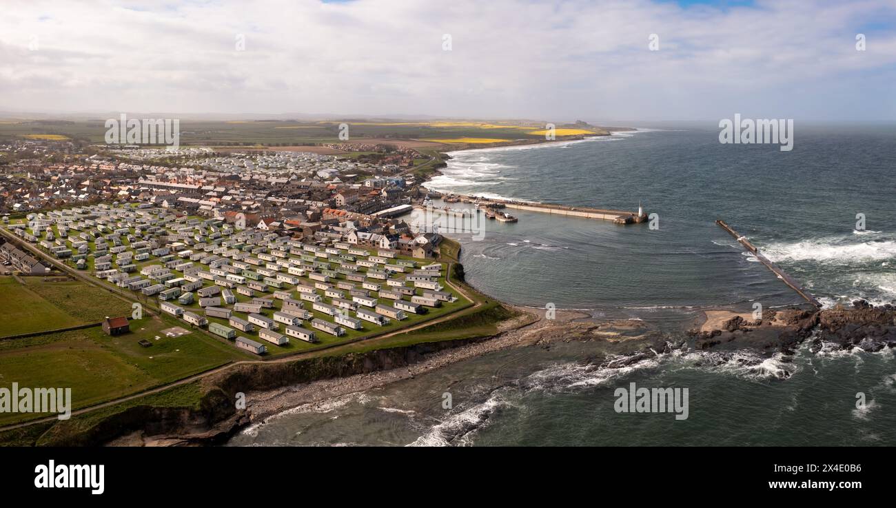 Aerial landscape panorama of the popular tourist resort of  Seahouses town and harbour with large caravan parks for seaside holidays in Northumberland Stock Photo