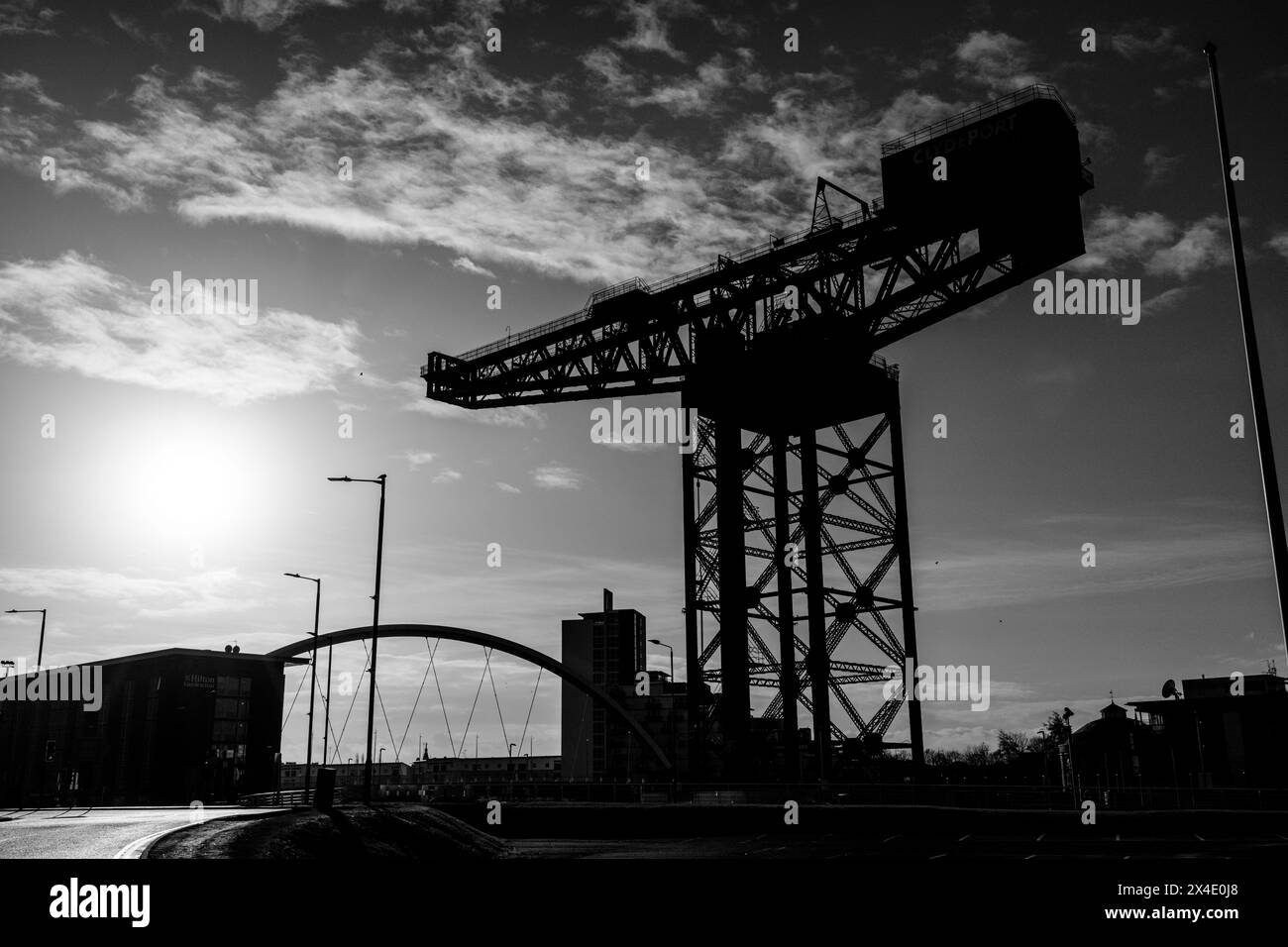 Glasgow Scotland: 13th Feb 2024: Finnieston Crane and The Clyde Arc on a sunny golden hour silhouette . Banks of the River Clyde Stock Photo