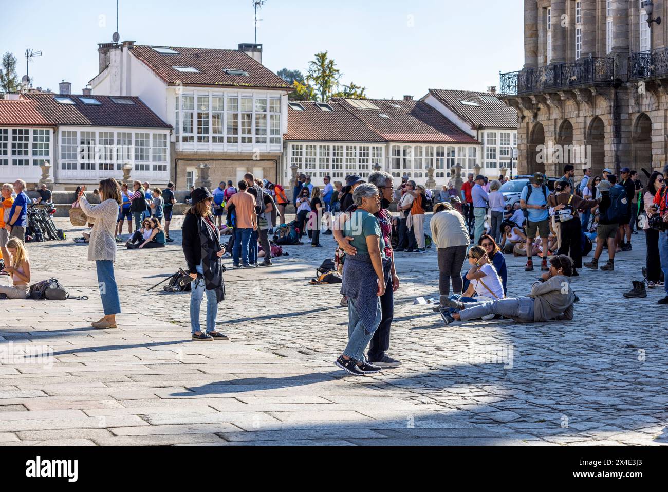 Spain, Galicia. Santiago de Compostela, pilgrims celebrating and relaxing in the square at the cathedral upon the completion of their Camino. (Editori Stock Photo