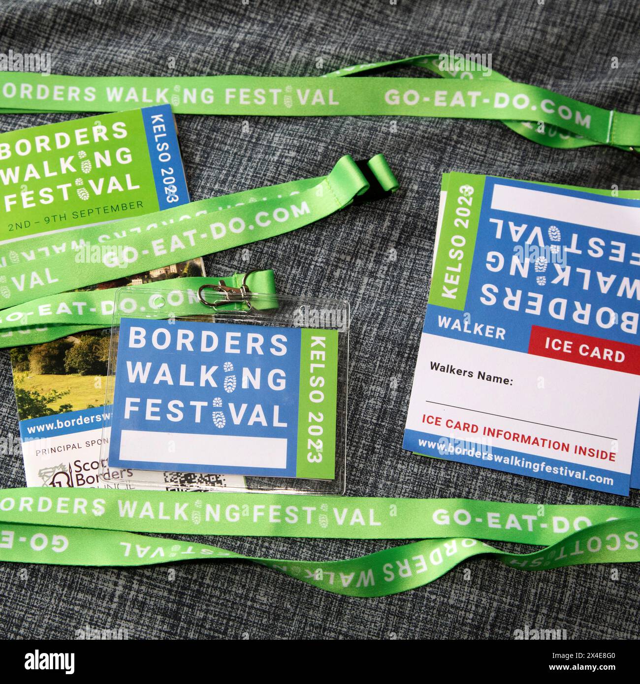 Lanyards, passes and information brochures for the 2023 Scottish Borders Walking Festival. The event was held in and around Kelso, Scotland. Stock Photo
