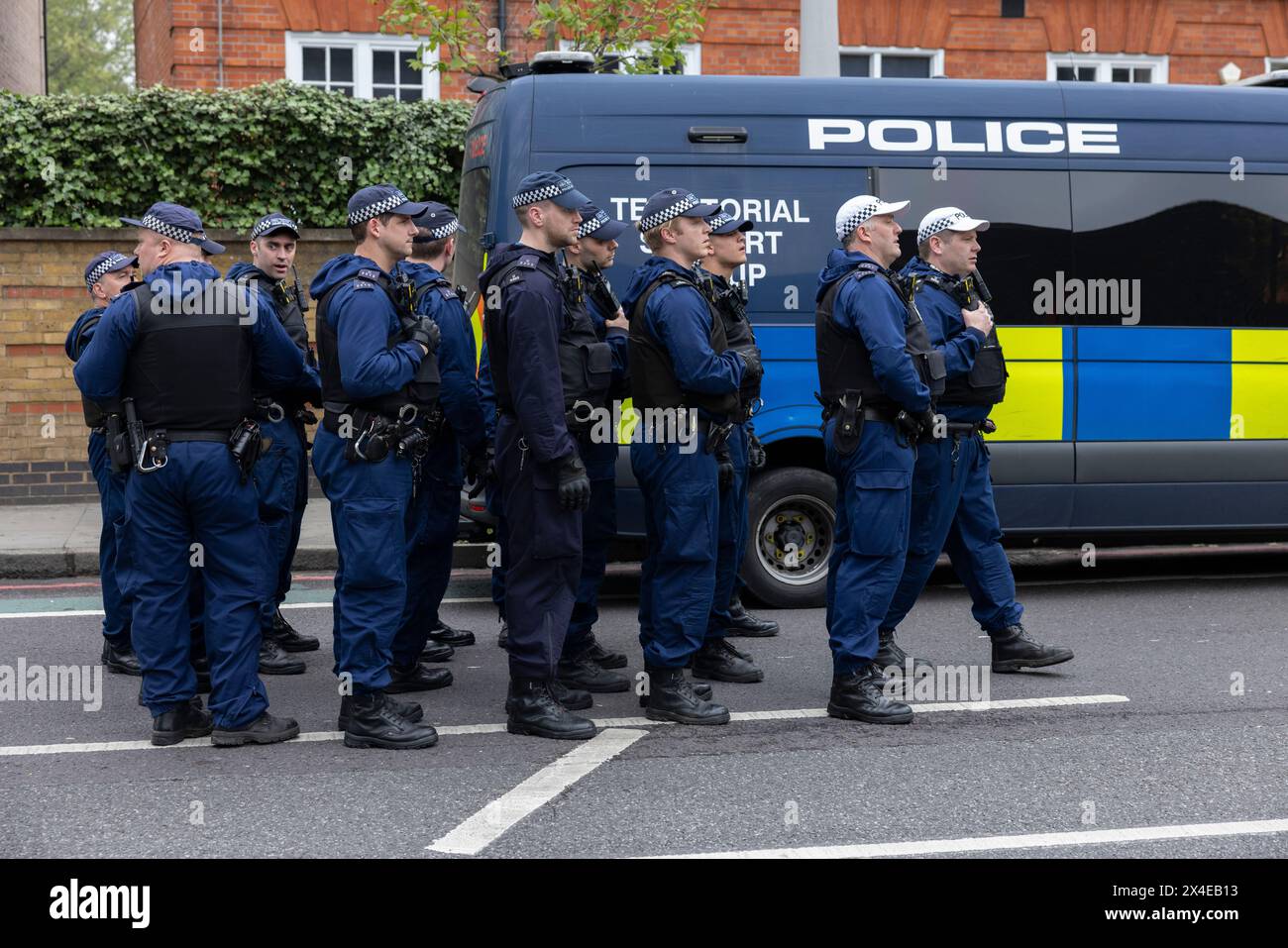 A coach sent to collect asylum seekers and take them to the Bibby Stockholm barge surrounded by protesters in Peckham south London England, UK Stock Photo