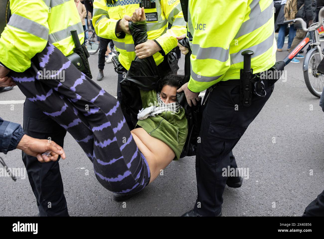 A coach sent to collect asylum seekers and take them to the Bibby Stockholm barge surrounded by protesters in Peckham south London England, UK Stock Photo