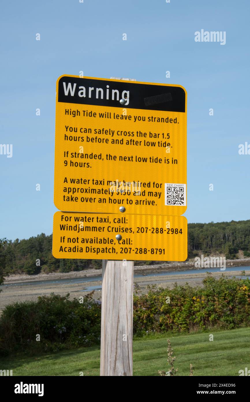 Hide Tide Low Tide warning sign at the sandbar for Bar Harbor Bar Island walking trail, Mount
