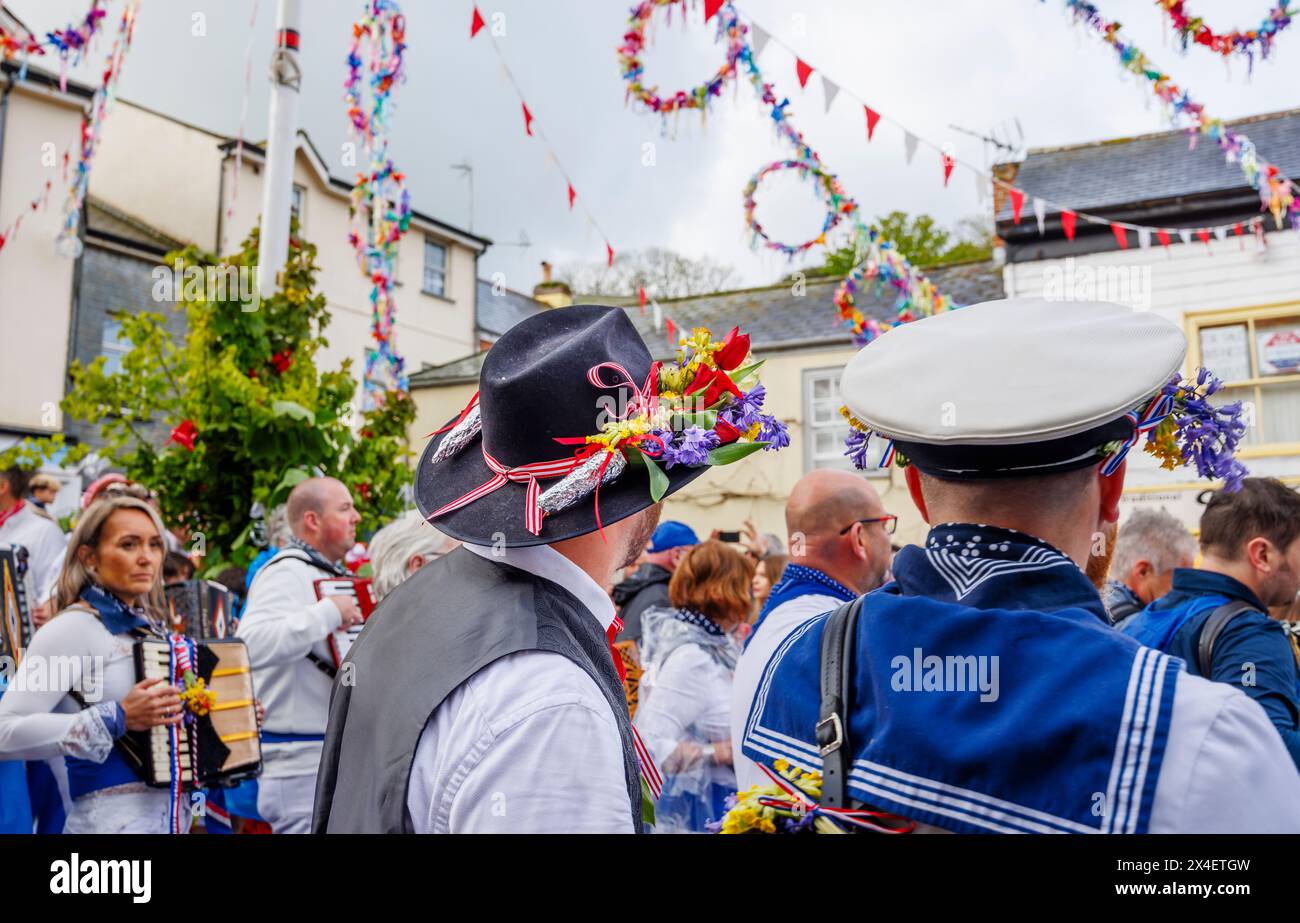 Participant wearing a hat and garland of bluebells and cowslips at the the 'Obby 'Oss festival, an annual folk event on May Day in Padstow, Cornwall Stock Photo