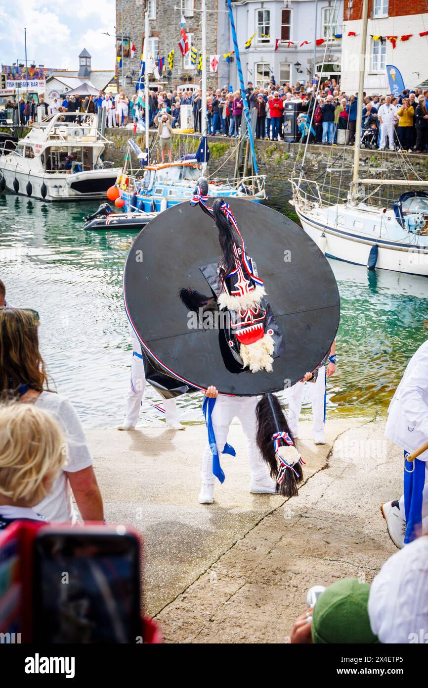The Blue 'Oss by the harbour at the 'Obby 'Oss festival, a traditional annual May Day folk event in Padstow, a coastal town in Cornwall, England Stock Photo
