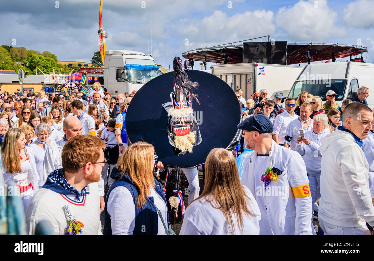 The Blue Ribbon 'Oss and performers parading in the streets at the 'Obby 'Oss festival, a traditional annual May Day folk event in Padstow, Cornwall Stock Photo