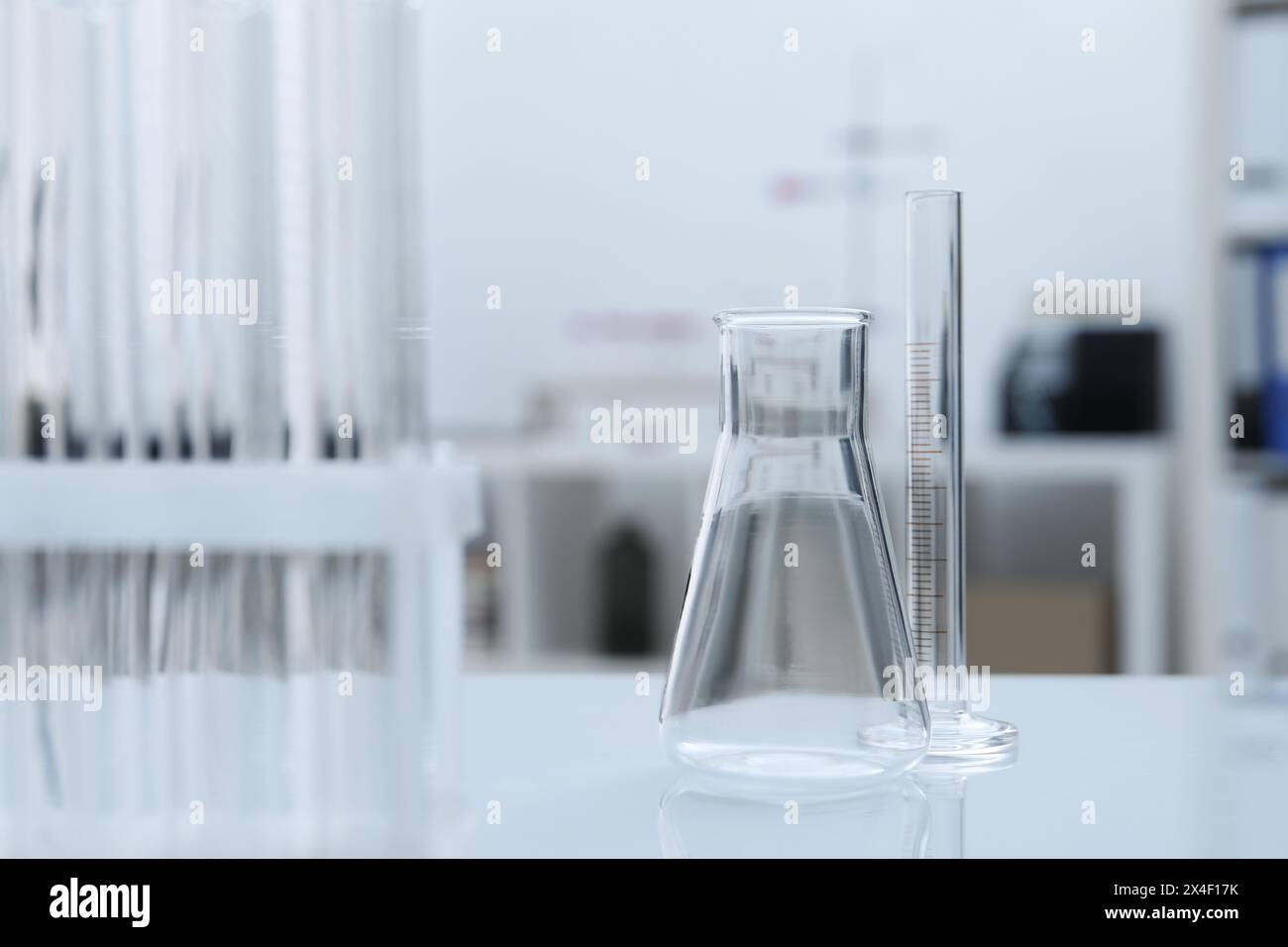 Laboratory analysis. Flask and test tubes on white table indoors Stock ...