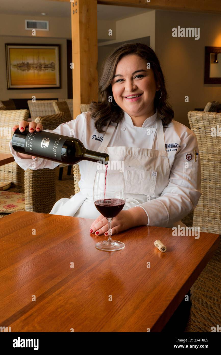 USA, Washington State, Richland. Chef Pauline Garza, samples red wine. (Editorial Use Only) Stock Photo