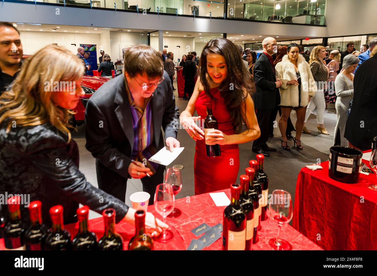 USA, Washington State, Bellevue. Guests samples dozens of Washington wines at the Cabernet Classic at Bellevue Porsche. (Editorial Use Only) Stock Photo