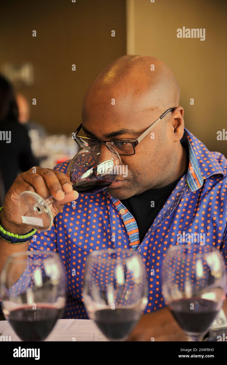 USA, Washington State, Richland. Judge evaluates red wine at wine competition. (Editorial Use Only) Stock Photo